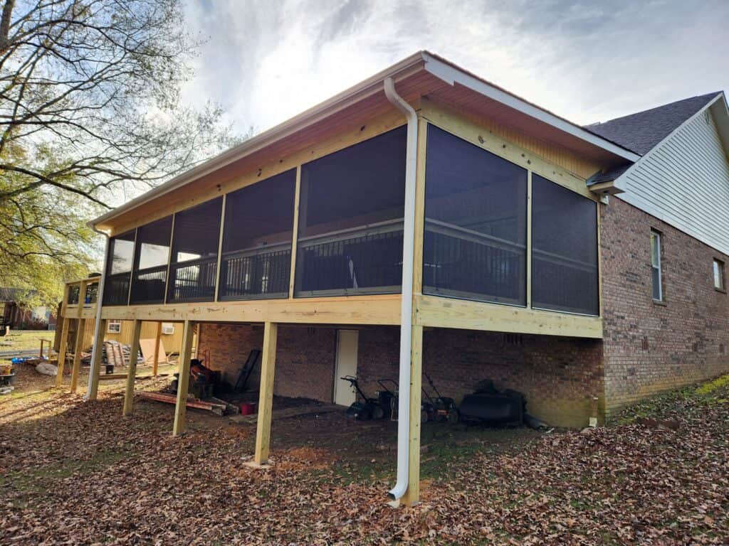 Custom screened porch in Mountain Brook, Alabama, built beneath a raised deck.