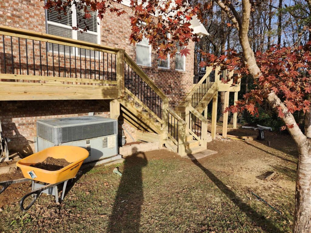 Custom deck and stairs at a brick home by Elite Decks, deck builder serving Fultondale, AL