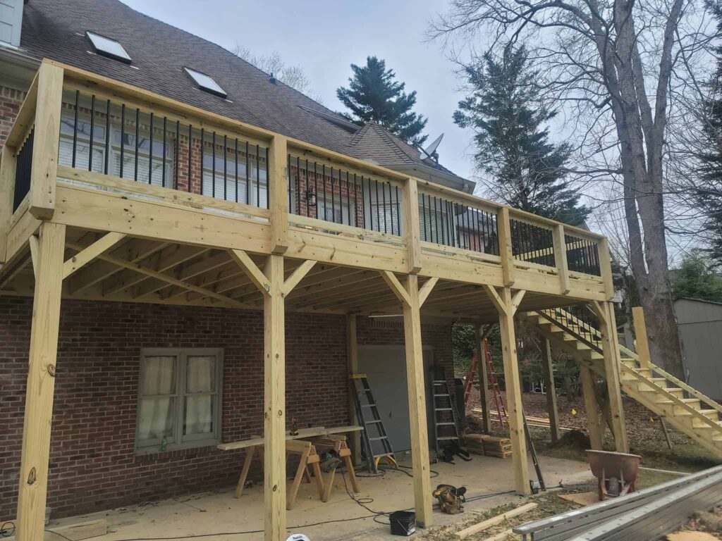 Custom deck with railing and stairs by Elite Decks, deck builder serving Helena, AL