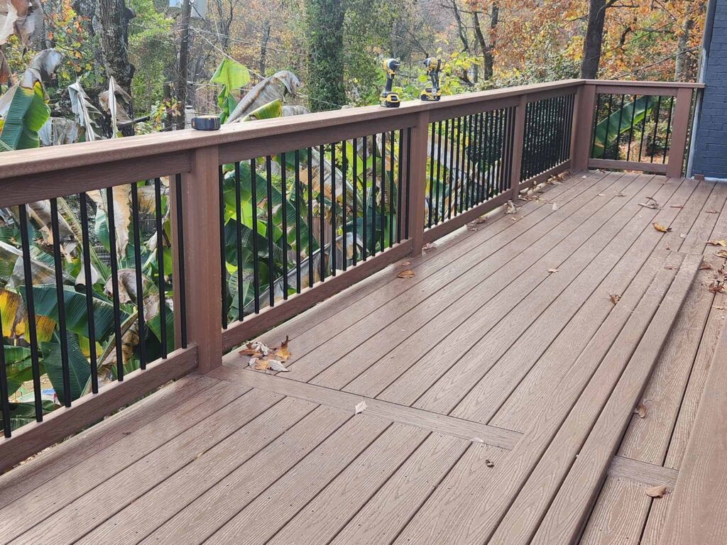 Custom deck with composite decking and black railings by Elite Decks, deck builder serving Kimberly, AL